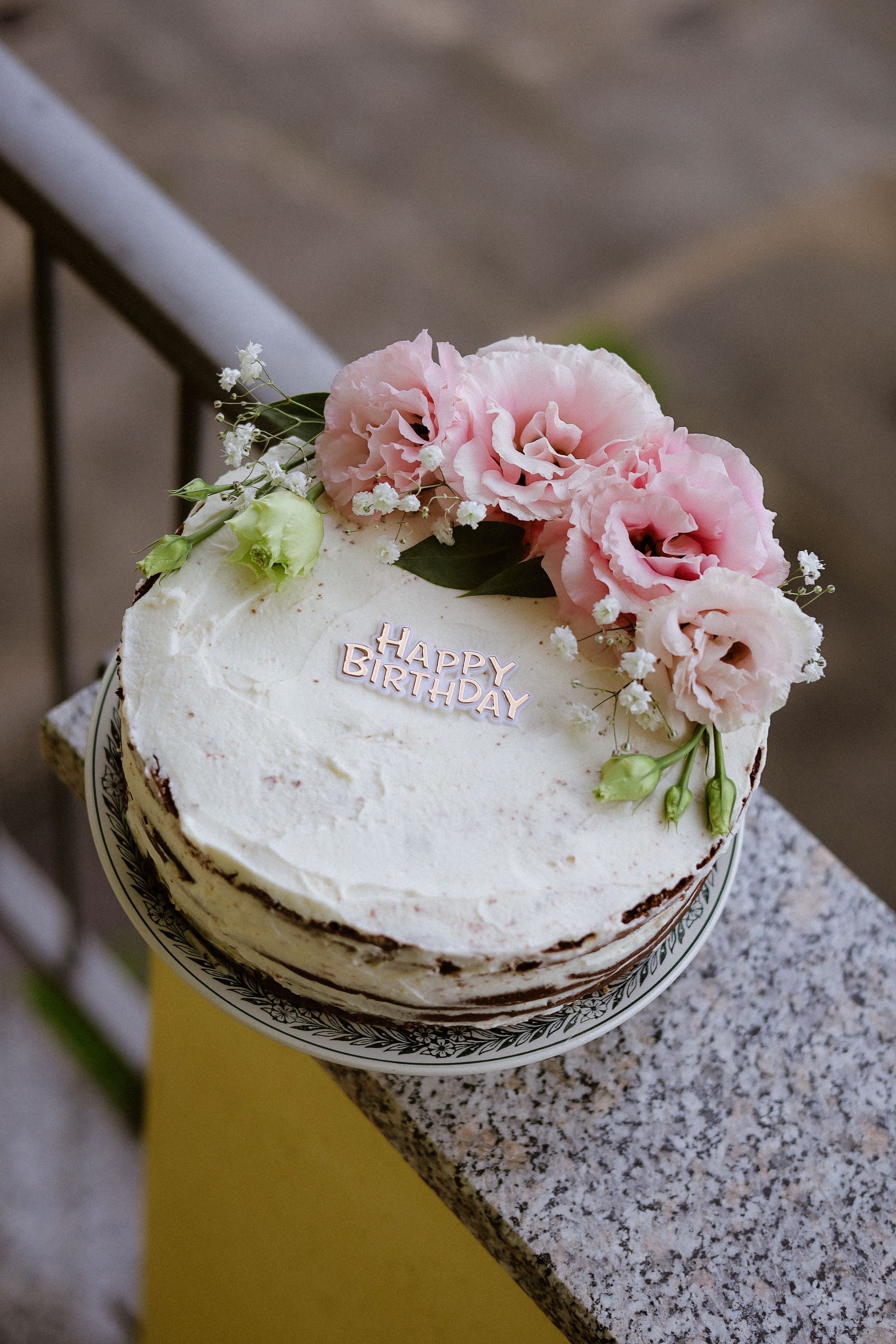Floral birthday cake with a Happy Birthday topper