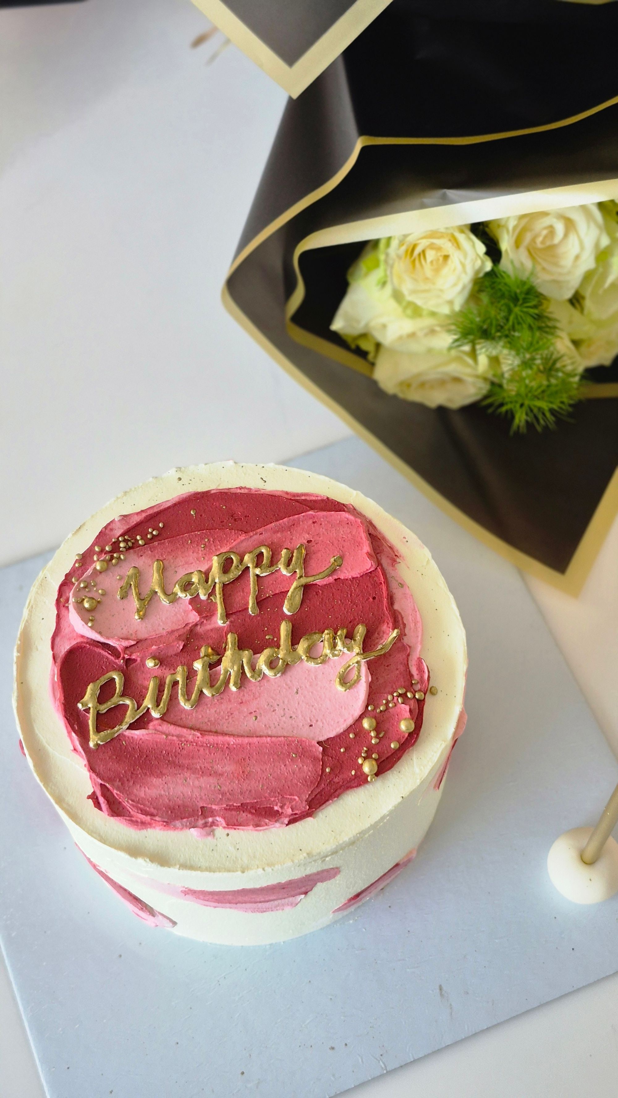 Blush and gold Happy Birthday cake with white roses