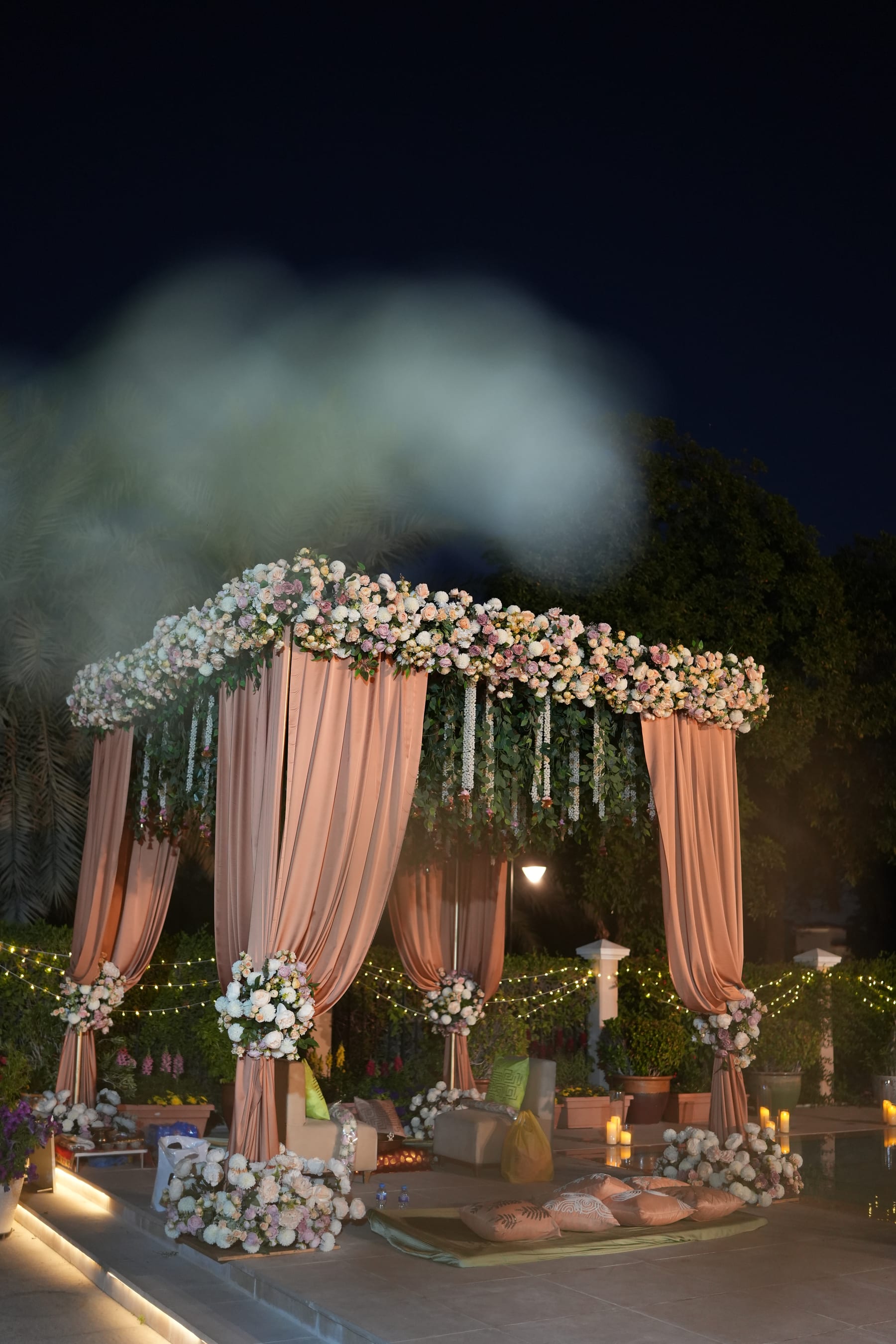 Floral mandap with blush drapes and hanging garlands
