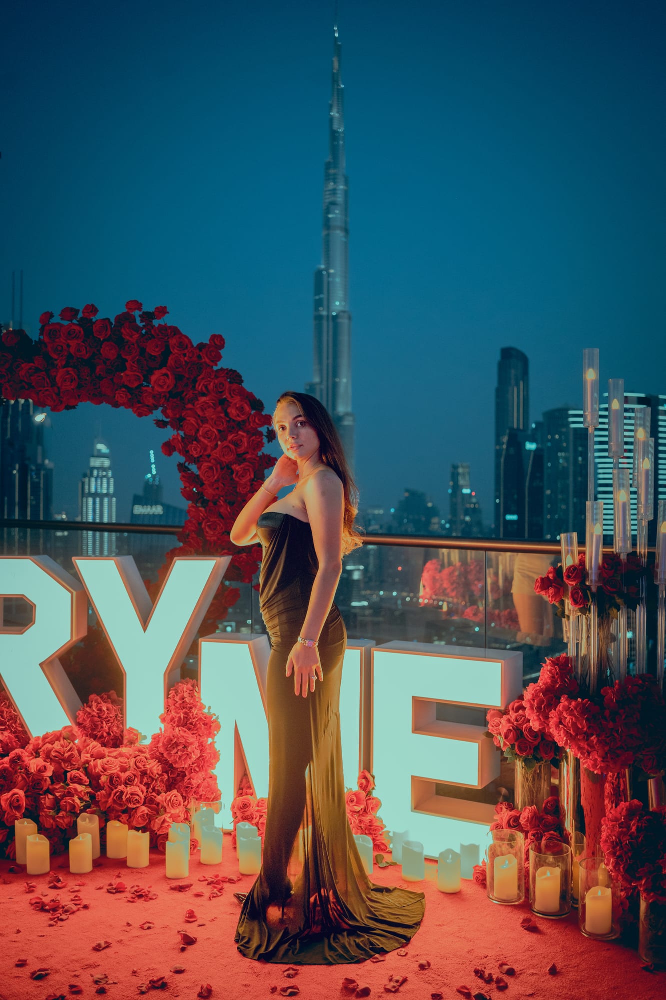 Night proposal with marquee letters and a rose arch