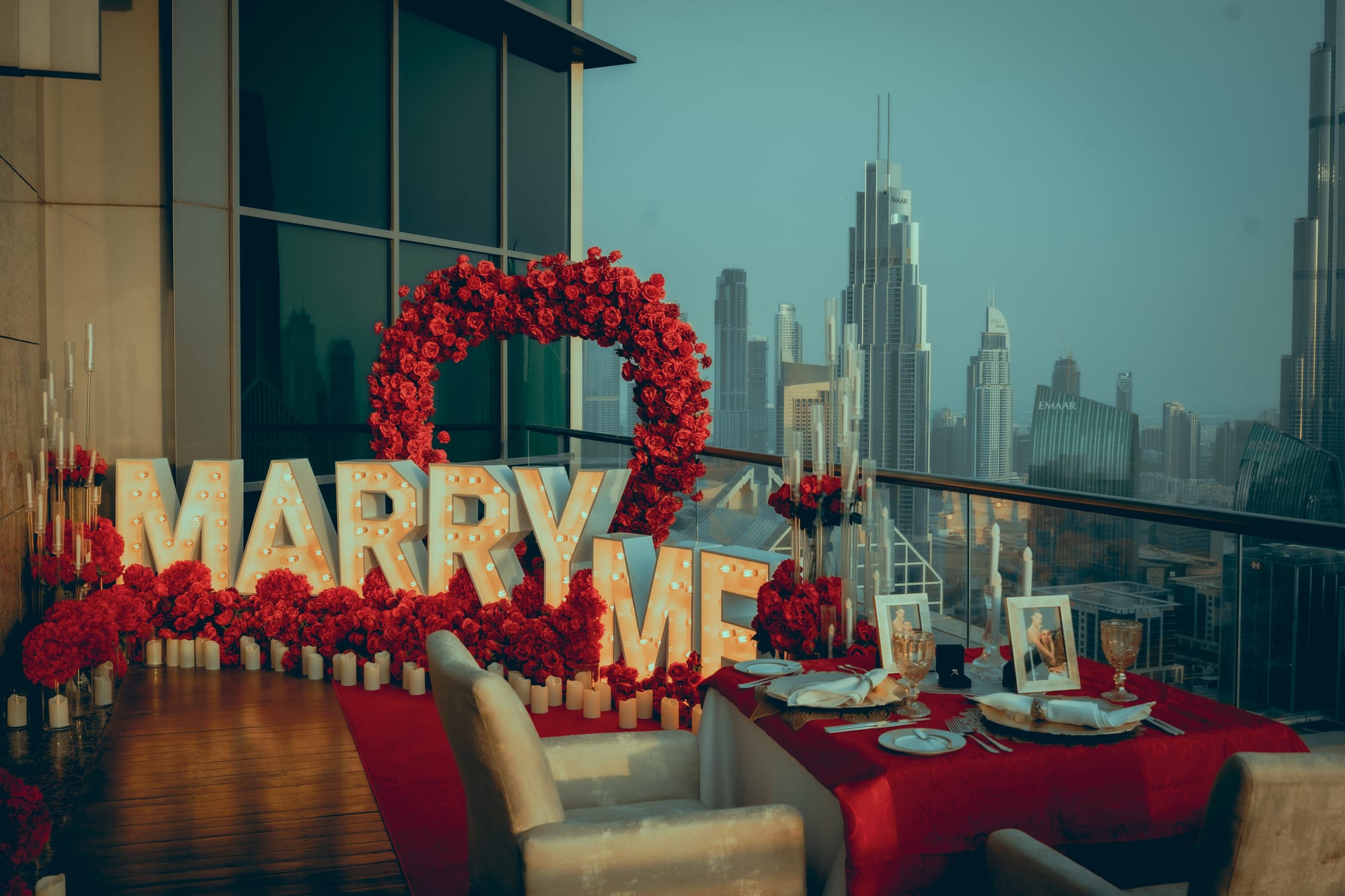 Rose arch, marquee letters, and a dinner table set on a terrace