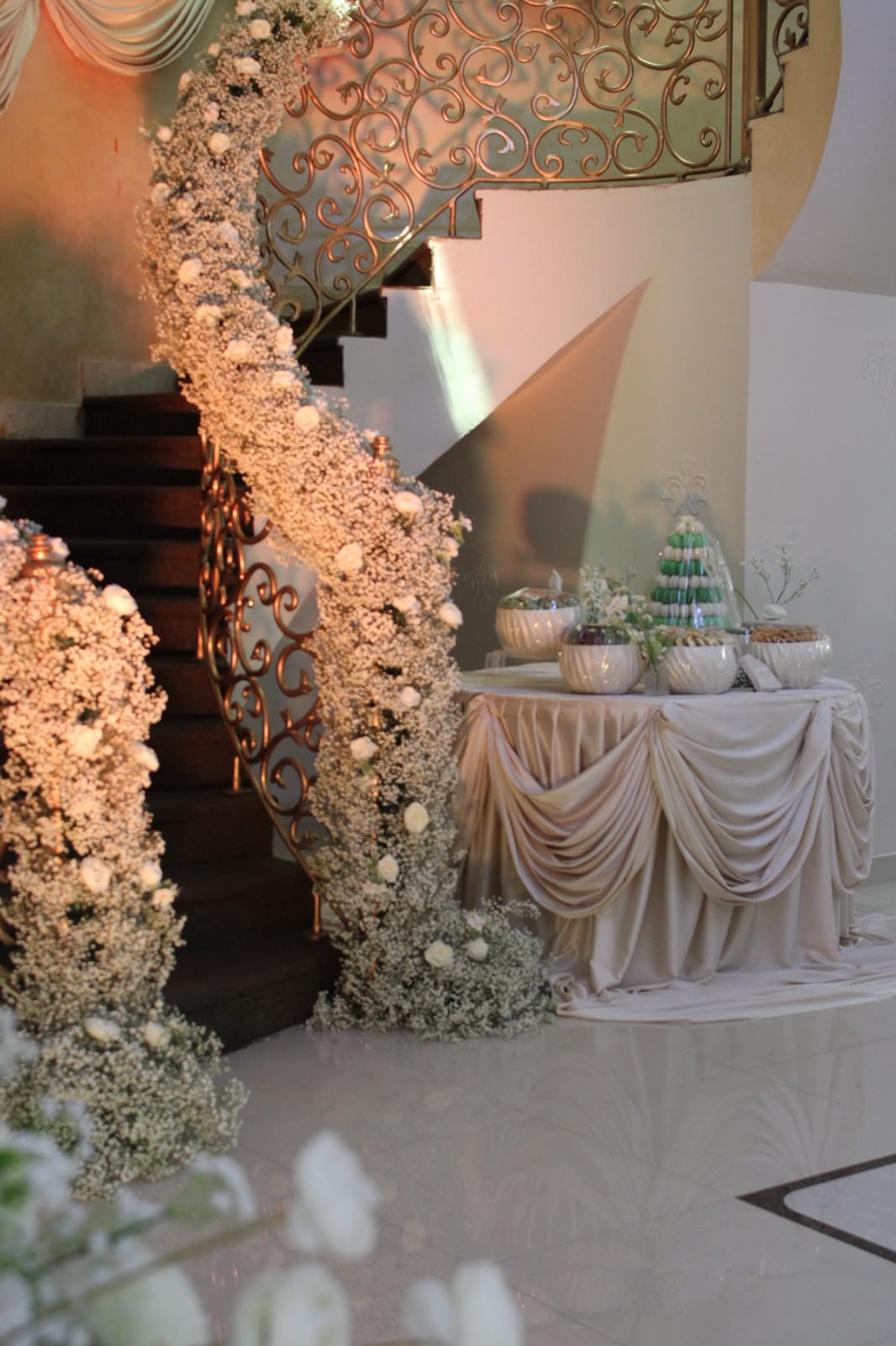 Villa staircase dressed with white roses and a welcome table