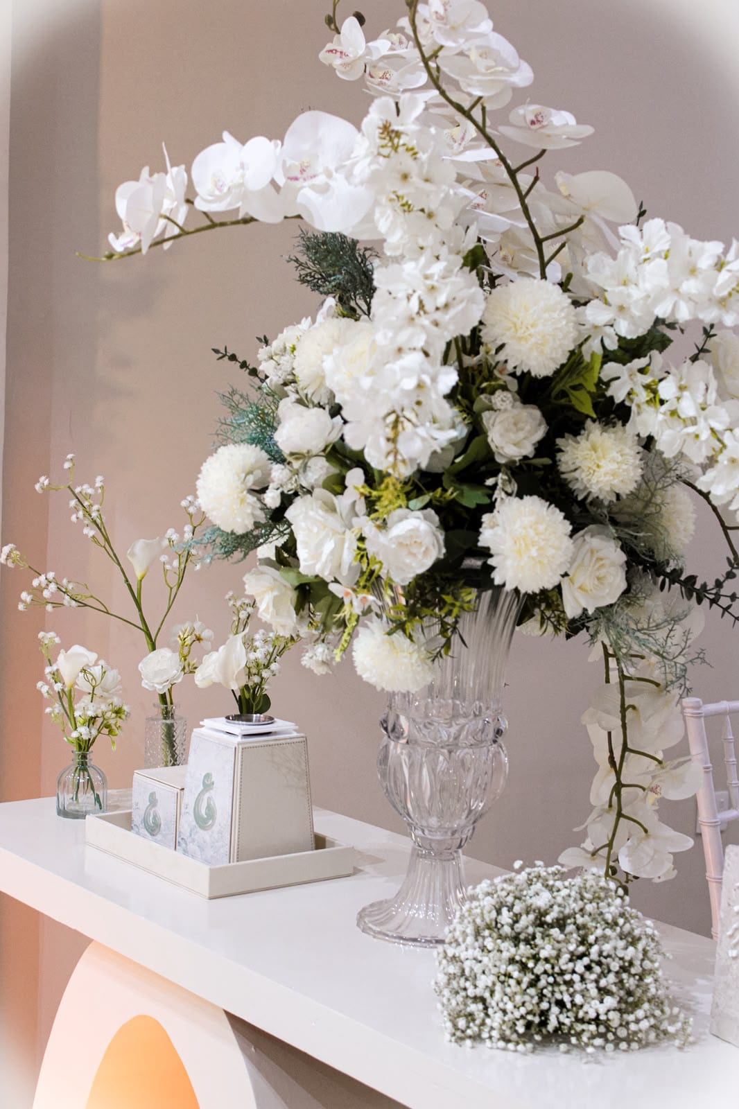 White orchid and rose arrangement in a crystal vase