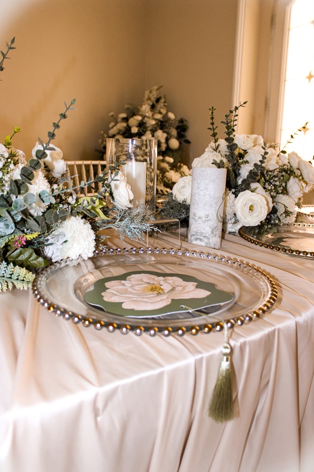 Place setting with a floral charger and candlelight